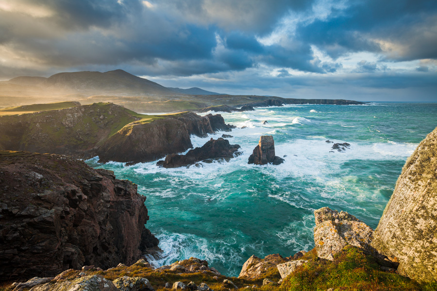 The storm of the previous day was starting to ease to a mere gale as I perched on the cliff top at dawn, steadying my tripod...