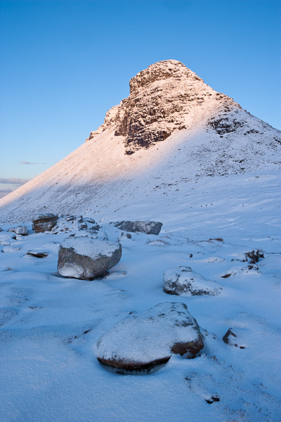 The first rays of sunlight were just peeking from behind the Assynt mountains to illuminate the snow covered peak of Stac Pollaidh...
